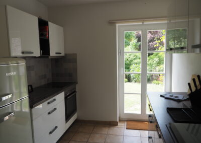 Die Küche der Ferienwohnung mit Ausgang zum Garten.